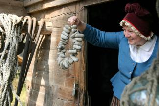 Woman wearing traditional costume in a museum.
